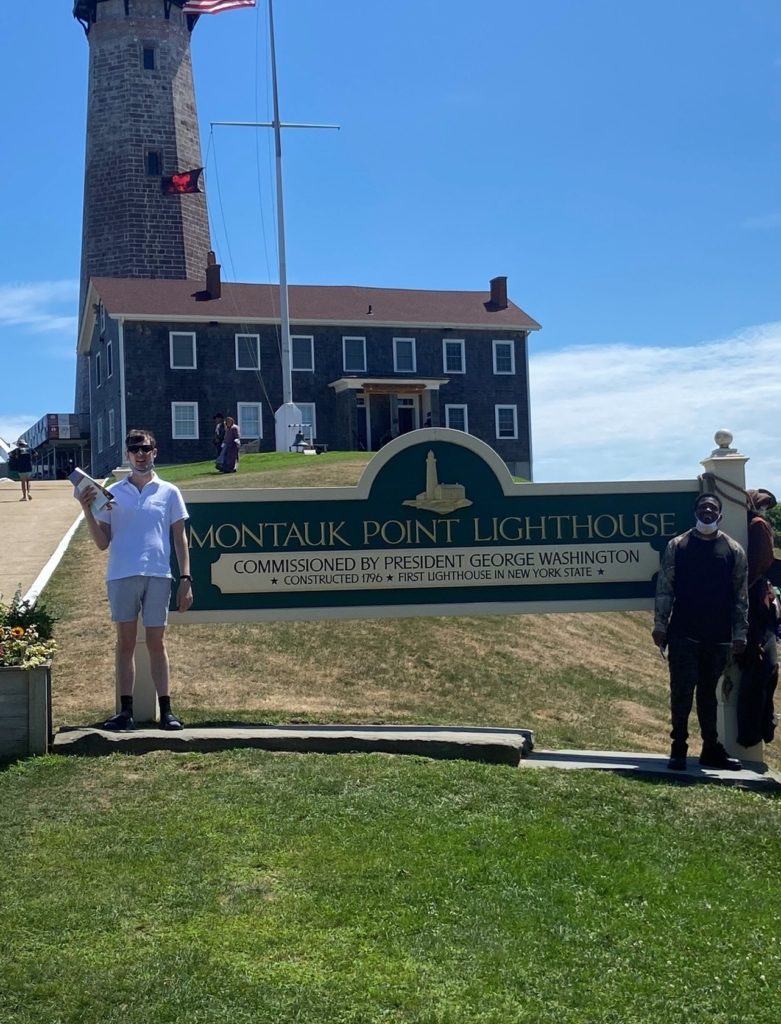 Montauk Light House 2 | Citizens Options Unlimited Manor Road residents in front of the "Montauk Point Lighthouse" sign at the Montauk Lighthouse