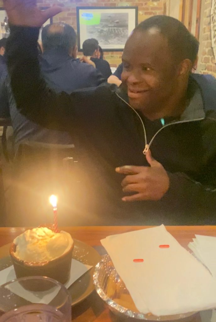 Raj | Citizens Options Unlimited Raj celebrating his birthday with a birthday cake and candle