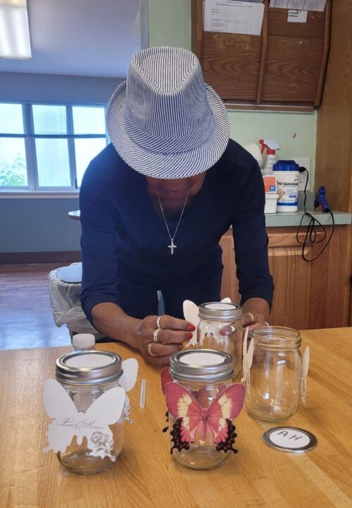 Chantal Joseph crafting butterfly jars for her Saturday respite crew
