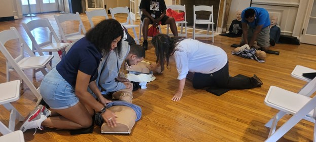 People supported learn CPR as part of the emergency preparedness event for Patriot Day