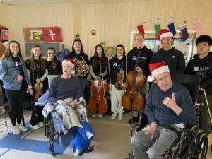Residents at Shoreham ICF with the Tri-M Music Honor Society from Shoreham Wading River High School