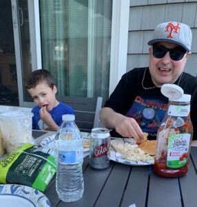 A photo of David and his nephew Lucas eating BBQ together