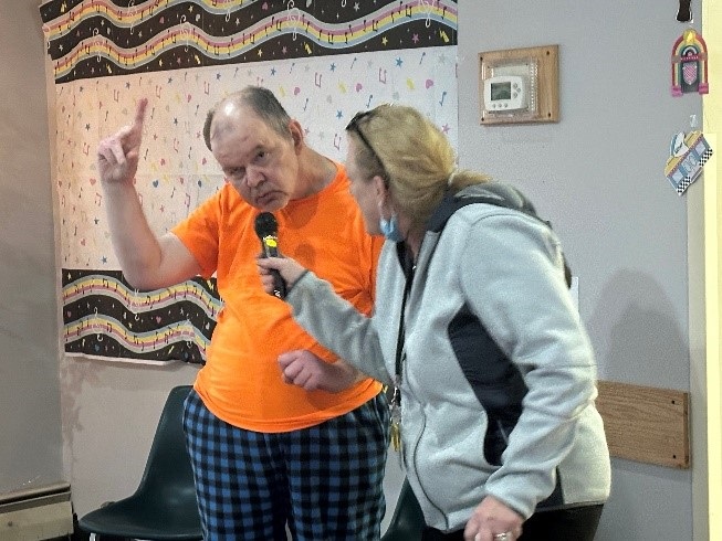 A Shoreham resident sings with a staff member.