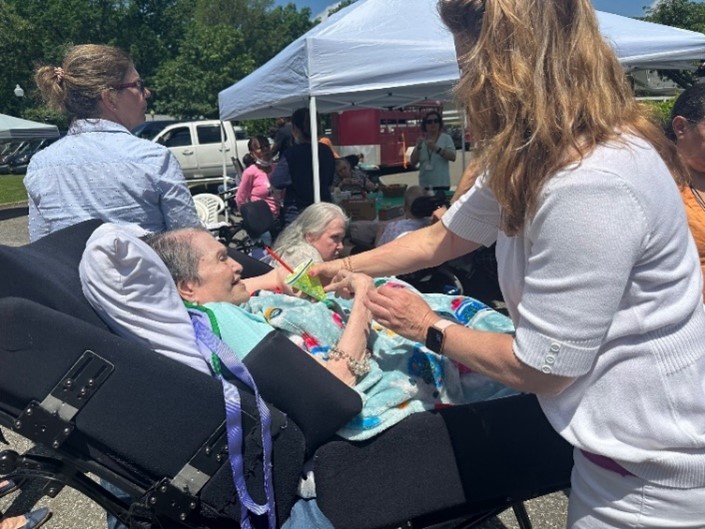 helen kaplan center farm 4 | Citizens Options Unlimited Guardianship Manager Eileen Stewart-Rooney handing Roz Adler, a resident, a lemon-lime snow cone.