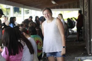 A camper smiles under the outdoor covering.