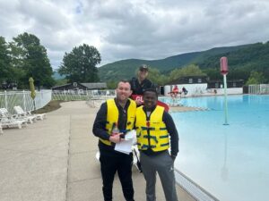 Camp Loyaltown staff and campers pose by the pool