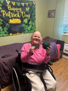 A resident at the Shoreham Intermediate Care Facility with her St. Patrick's Day decorations.