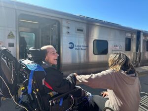 Bobby and staff member Norma watching trains at the train station.