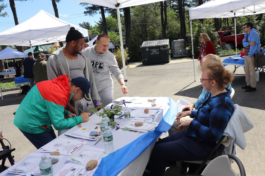Self-advocates paint rocks at the Day of Community Engagement