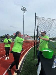 A resident passes out water to a Walk-a-Thon participant