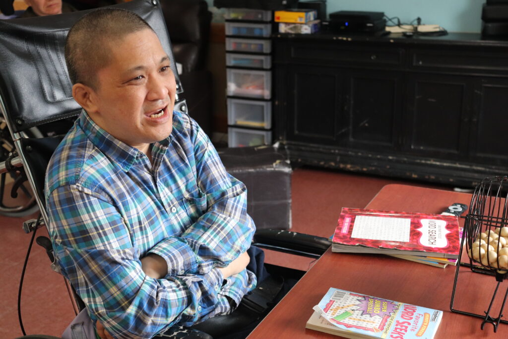 A person supported by Citizens sits at a table.