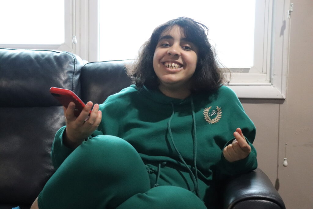 A person supported by Citizens sits on a couch.