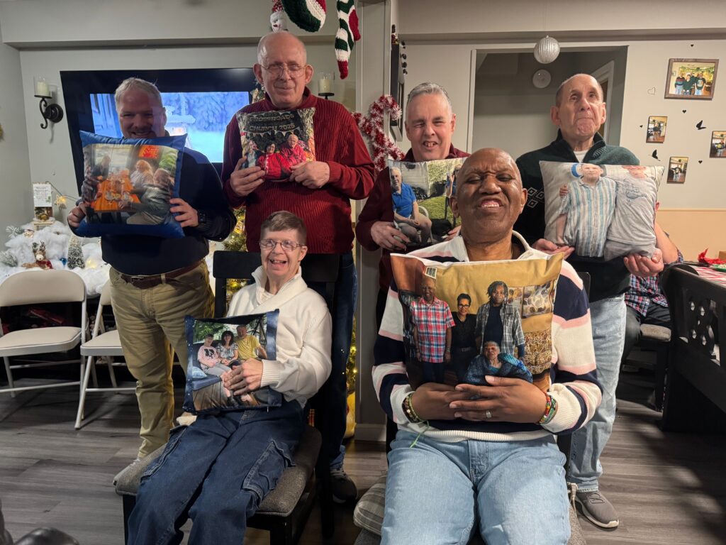 Six people supported by Citizens hold personalized pillows