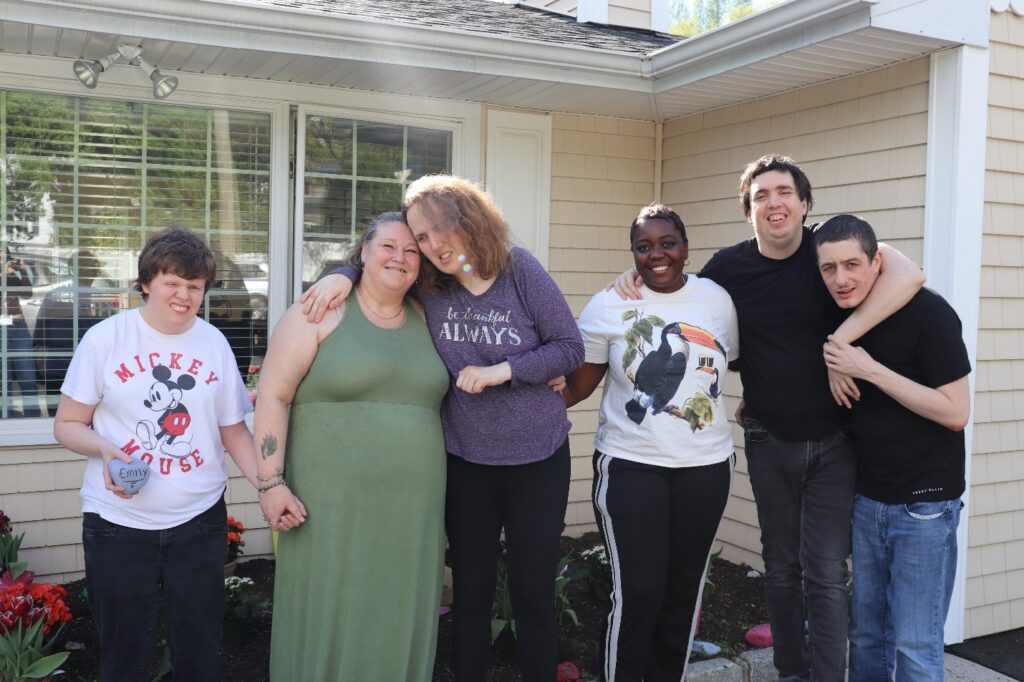Six Port Washington IRA residents and staff in front of their new sensory garden