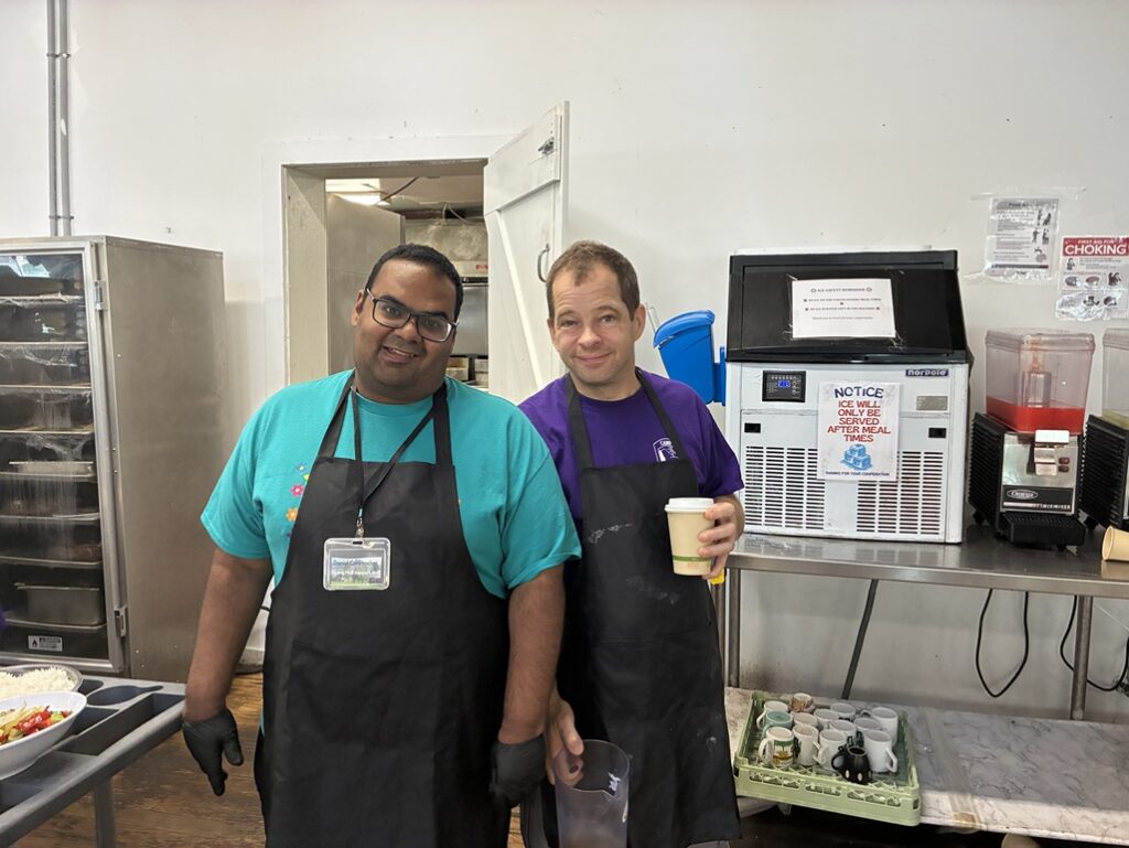 Two Camp Loyaltown campers work in the kitchen