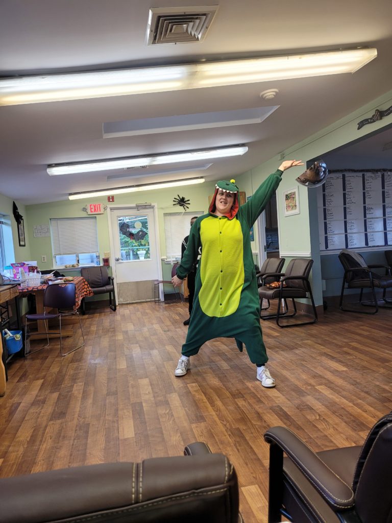 Man Poses in Dinosaur Costume