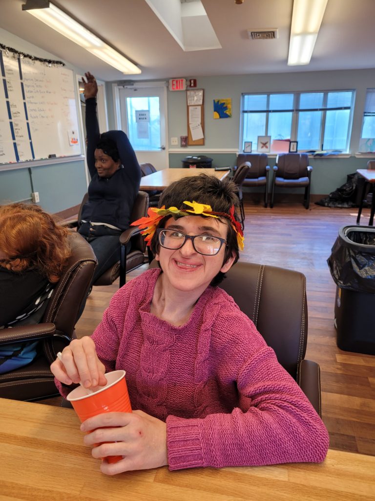 Woman with Leaf Headband Poses at Table