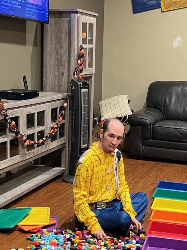 person in Woody from toy story costume sorts lego