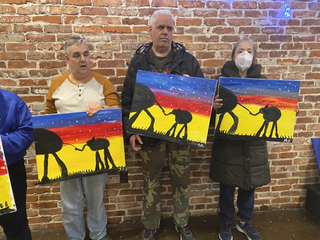 People supported showing off their paintings