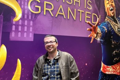 Man poses in front of Aladdin on Broadway