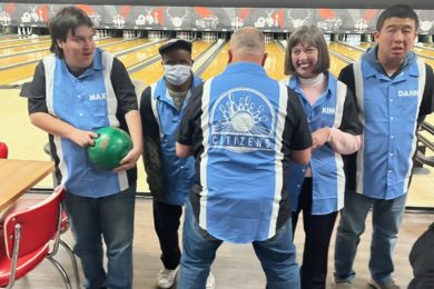 People supported show off their bowling shirts