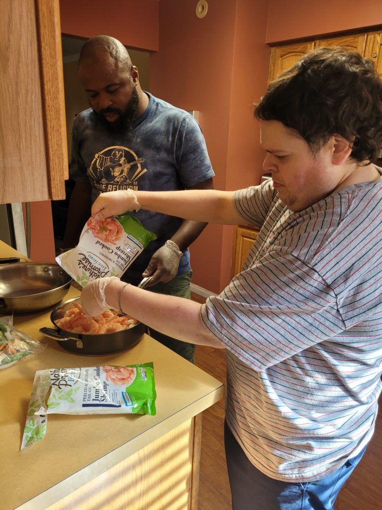 Noah cooking shrimp at the Carol Street residence