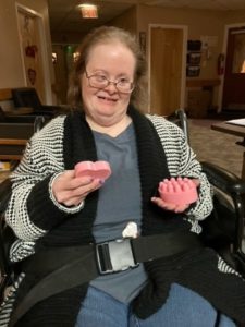 Person supported showing off her handmade soap