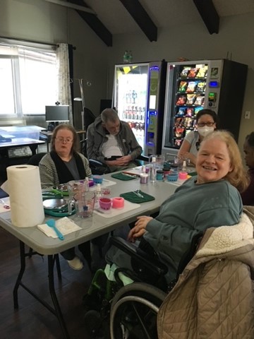 People supported learning to make soap