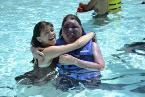 Campers and staff enjoy the pool at Camp Loyaltown