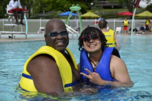 Campers enjoy swimming in the pool at Camp Loyaltown