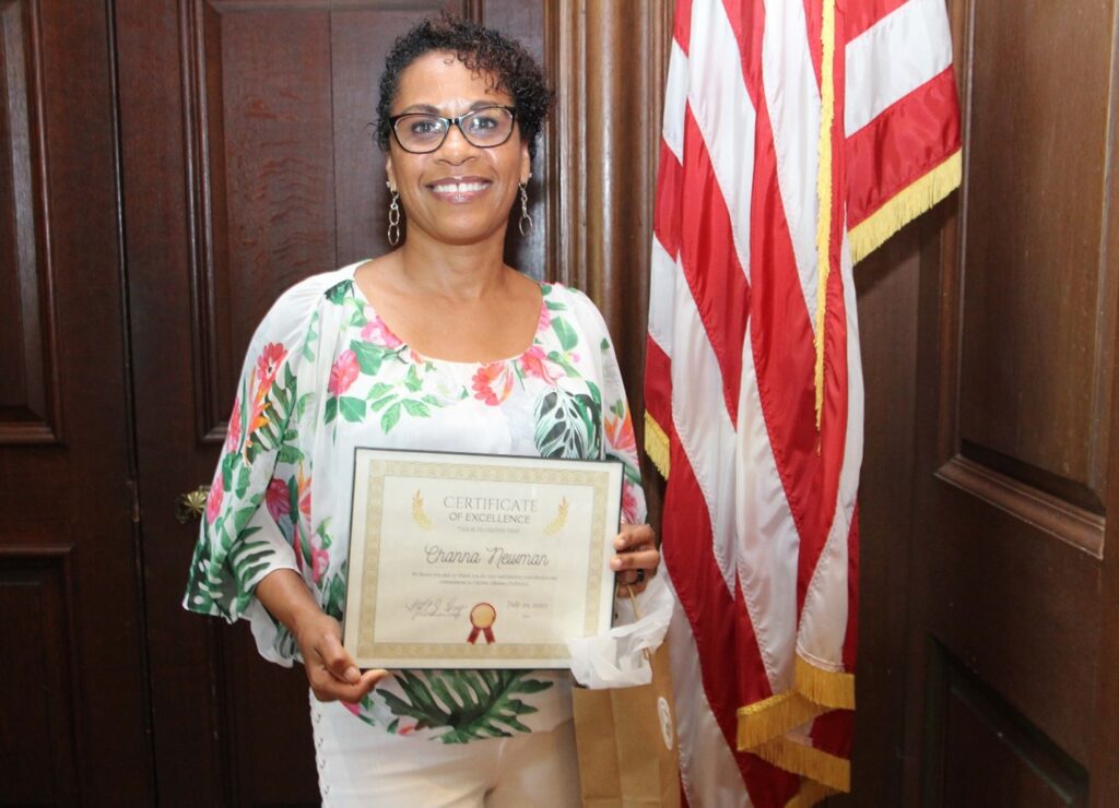 Channa Newman poses with her Employee of the Quarter certificate