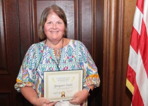 Georgeann Sciulla poses with her Employee of the Quarter certificate