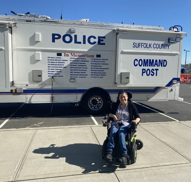 Christina Paz poses in front of a Suffolk County Police vehicle