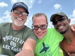 Schnyder poses with our COO and a camper at Camp Loyaltown