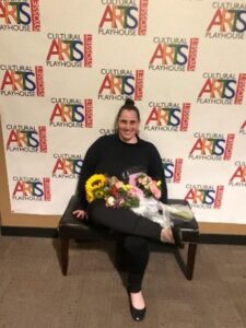 Tanya Castiello poses with flowers after her theater performance