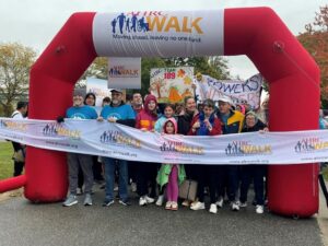 Walkers get ready to cut the ribbon at the AHRC Foundation Walk
