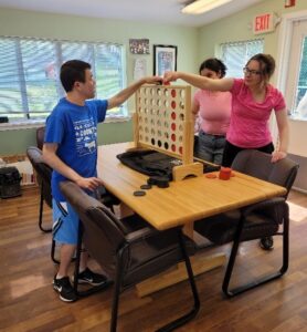 People supported by Citizens playing games together