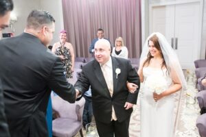 A photo of David walking Hallie down the aisle at her wedding