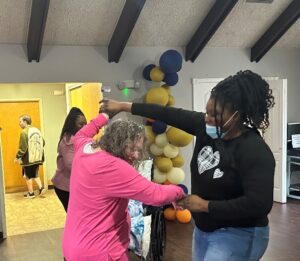 A Shoreham staff member dances with a resident during the bi-weekly event