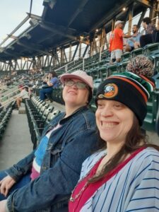 Syosset residents Lizzie and Jamie pose for a photo at a baseball game