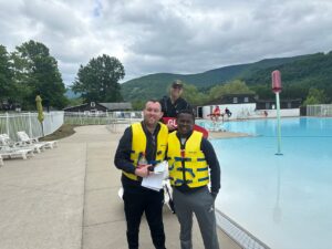 Unit Head of Programming Nyle Mohan and Unit Head Dirang Stephens Mataboge pose in front of the pool.