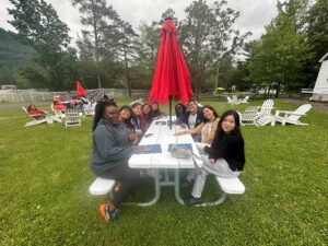 Camp Loyaltown counselors get to know each other around a picnic table