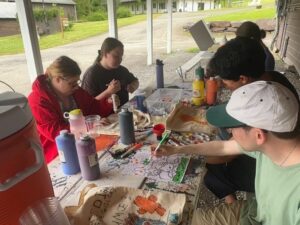 Camp Loyaltown campers enjoy painting outside