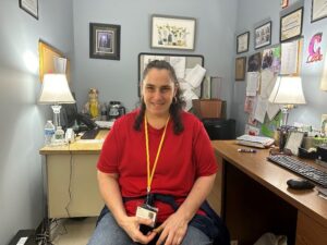 Self-advocate Tanya Castiello poses for a photo in her office