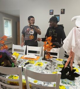 Two Red Spring Lane residents decorate the house with Halloween decorations.