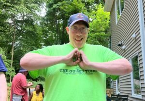 A person supported by Citizens Options Unlimited forms a heart with his hands