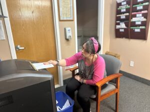 Volunteer Sarah Chardavoyne shredding paper at the Helen Kaplan Center ICF