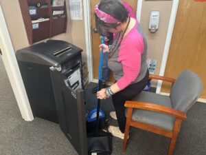 Volunteer Sarah Chardavoyne shredding paper at the Helen Kaplan Center ICF