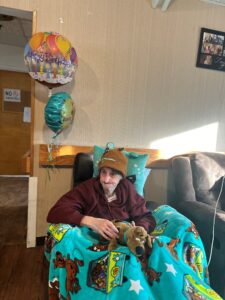 Shoreham Intermediate Care Facility resident Charlie Belasco with his Scooby-Doo blanket and stuffed animal