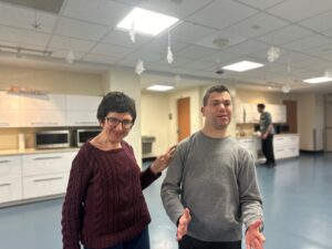 Two people supported by Citizens enjoying each other's company at weekend respite.